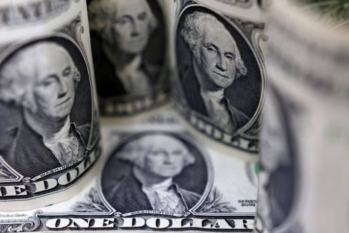 Dollar hits 4 week peak, then eases, sterling lower after BOE hike